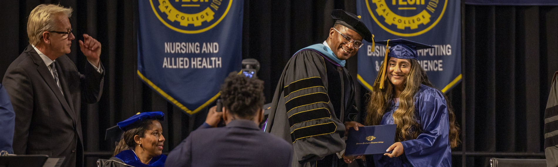 Dr. Ford poses for a photo with a graduating student.