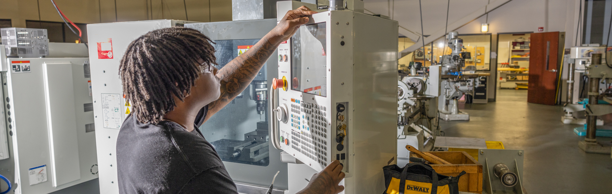 An FDTC student programs a CNC machine in the advanced manufacturing arena