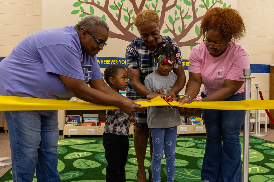 Children cutting the ribbon at the fdtc library children's section opening