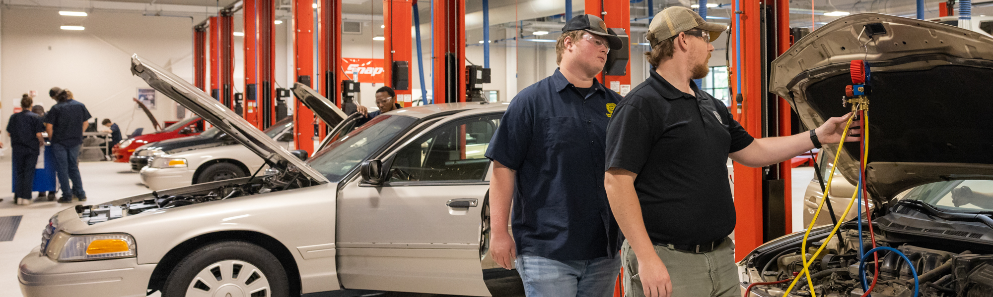 Automotive Technology students at FDTC work on a car in the automotive building shop