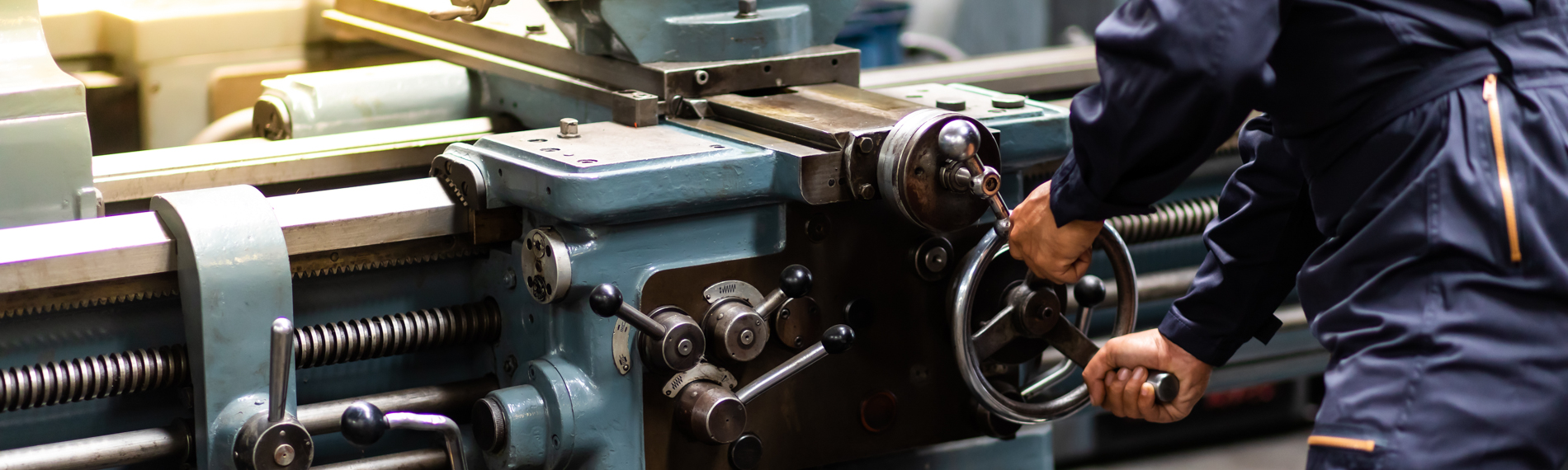 A student operates a metal lathe