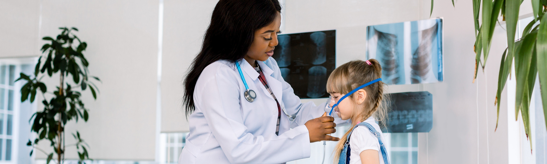 A respiratory care professional takes care of a young girl.