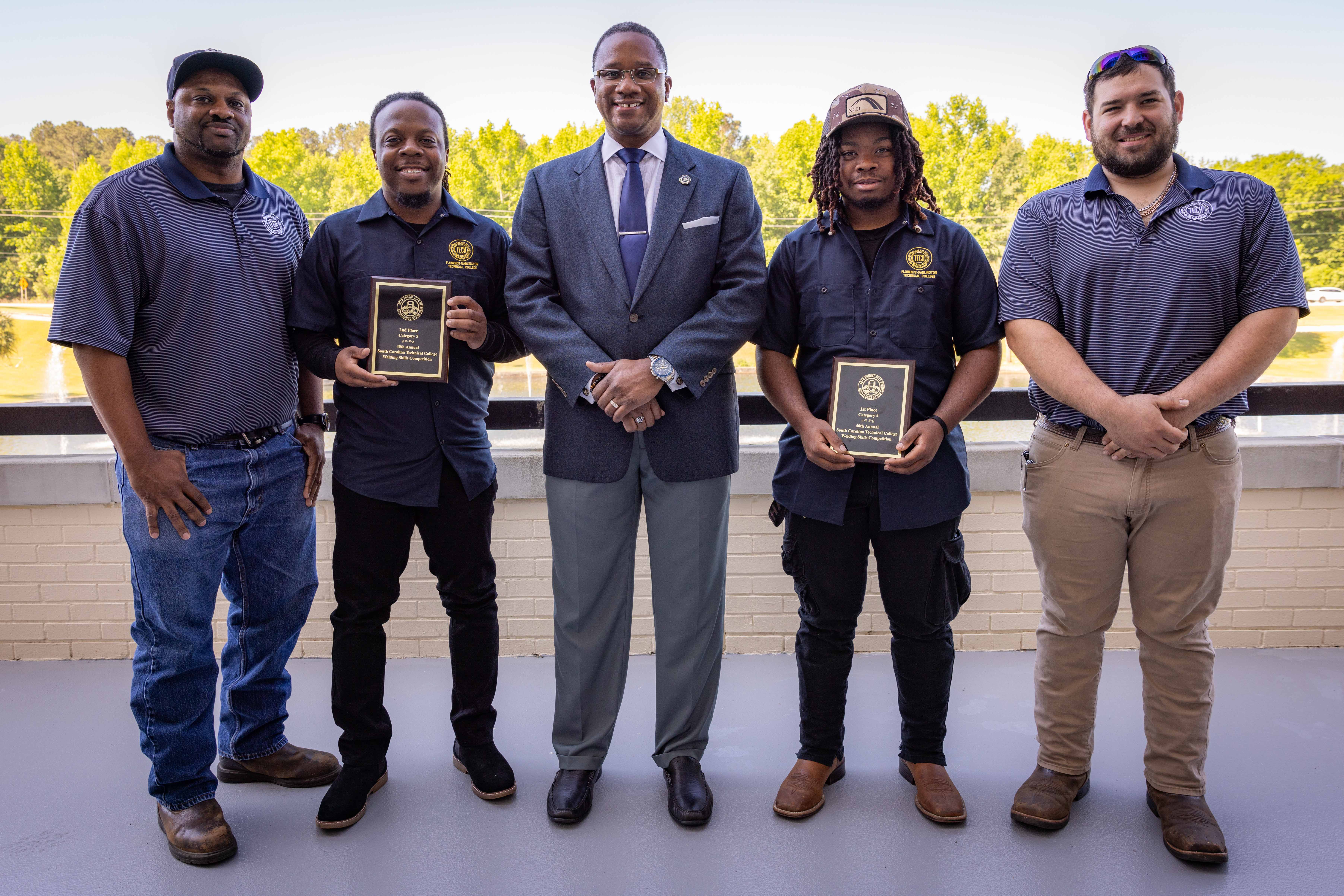 FDTC Welding Students pose for a photo with FDTC President Dr. Jermaine Ford on the balcony of the 5000 building.