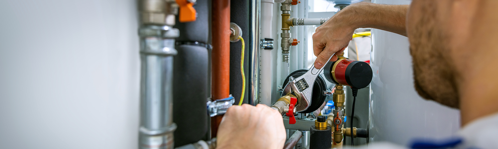 A plumber working in an industrial setting