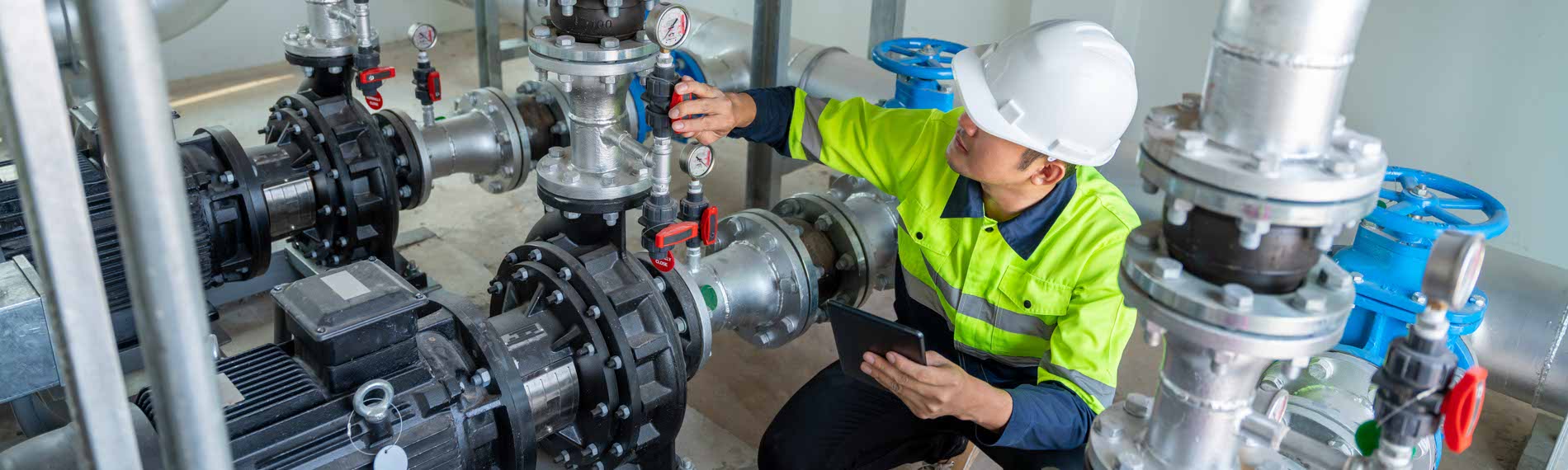 A valve technician inspecting a valve at a worksite.